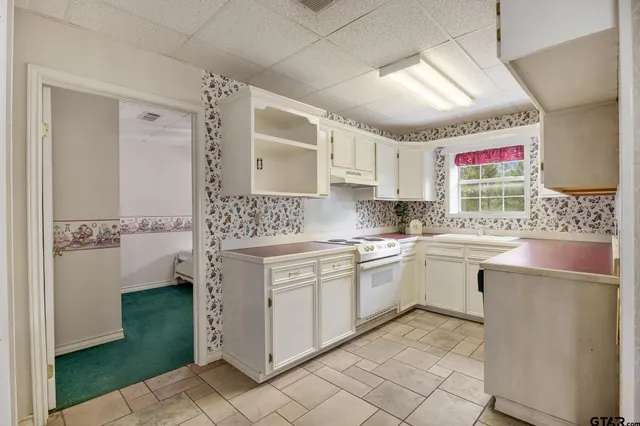 a kitchen with cabinets and window