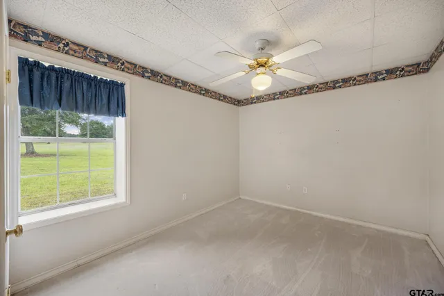 a view of a room with window and a ceiling fan