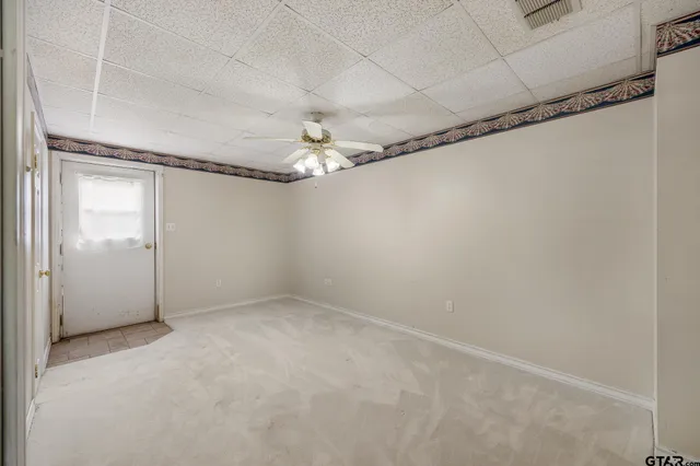 a view of a room with a mirror and a shower