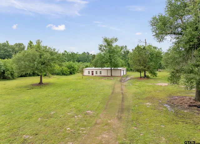 a view of a swimming pool with a yard