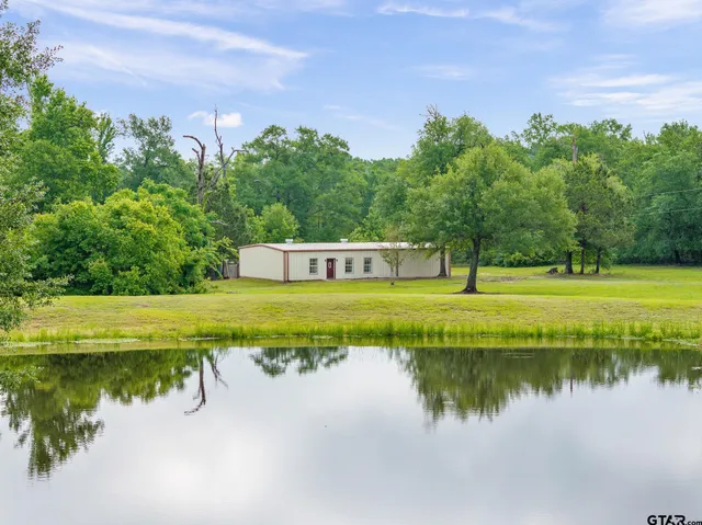 a view of building with river in front of it