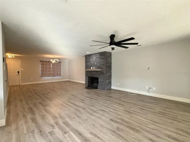 wooden floor in an empty room with a fireplace