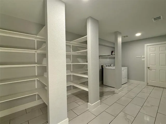 a view of walk in closet with empty racks