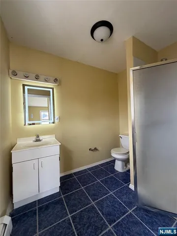 a bathroom with a toilet sink and a mirror