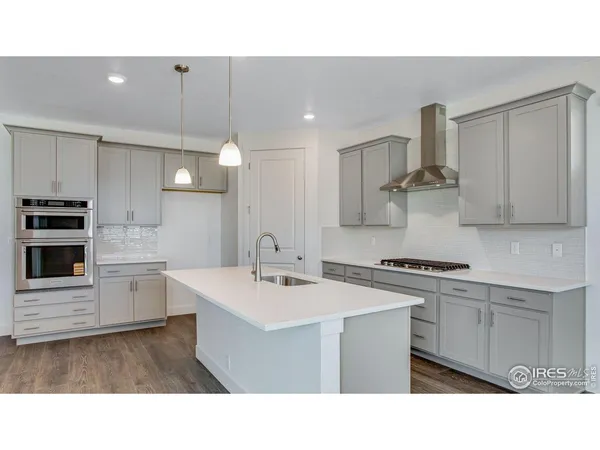 a kitchen with a table chairs and a refrigerator