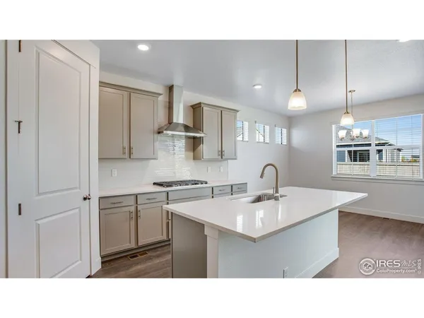 a open kitchen with a sink a refrigerator and a stove