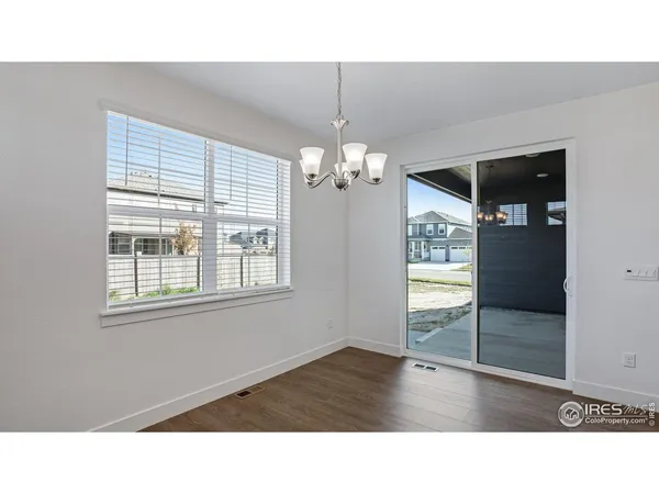 a room with wooden floor and windows