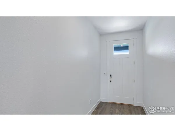a living room with a fireplace wooden floor and windows