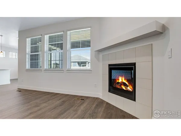a open hall with a fireplace and wooden floor