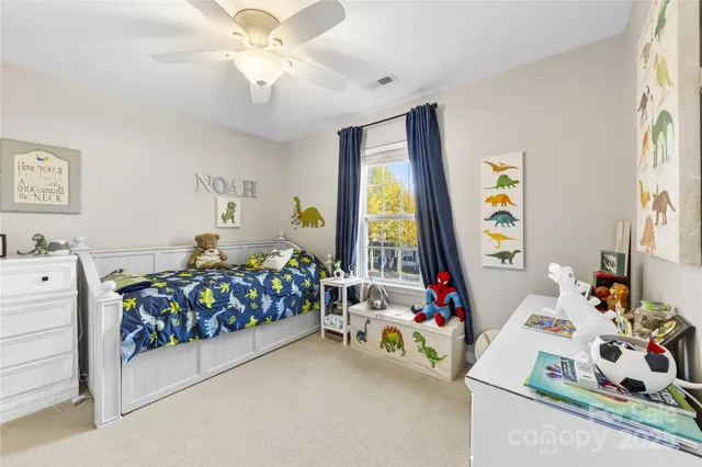 a bedroom that has a bed and a dresser in it