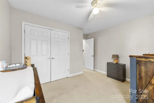 a large bedroom with bed and window