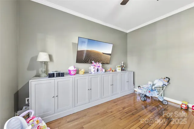a bedroom with furniture and a wooden floor