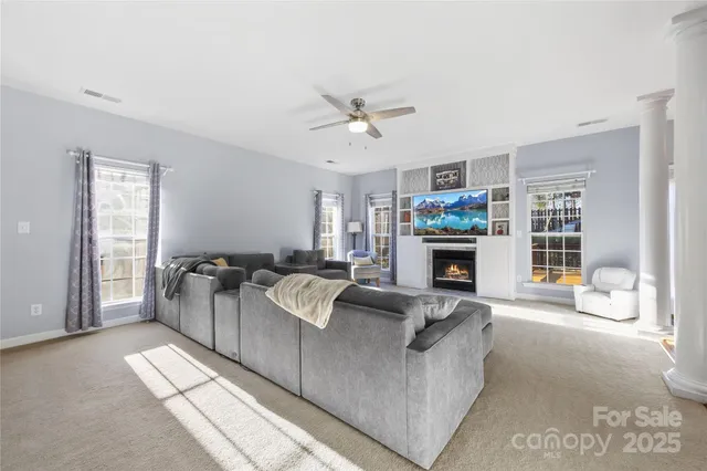 a living room with furniture and a fireplace