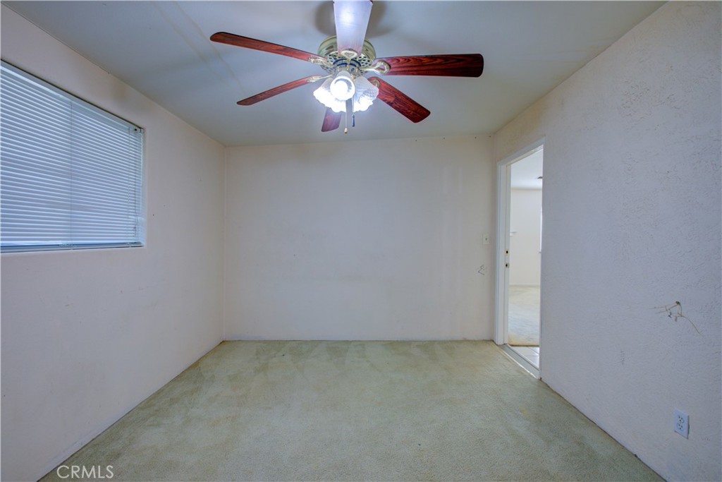 2341 Mesquite Court Merced, CA 95348 - Photo 14 of 17 an empty room with a chandelier fan and windows