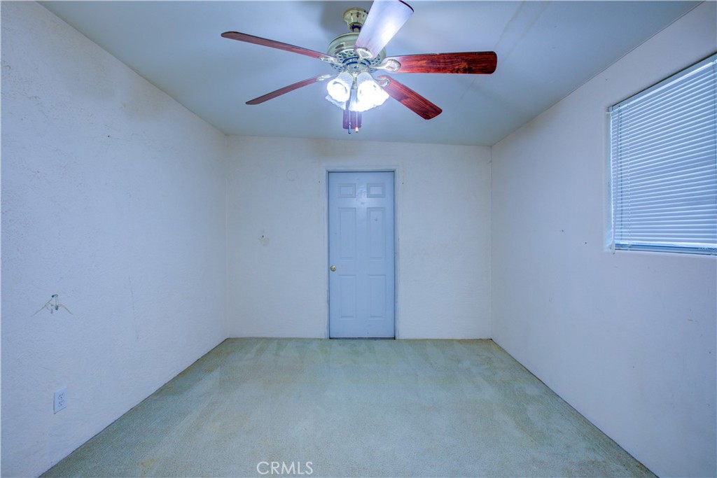 2341 Mesquite Court Merced, CA 95348 - Photo 15 of 17 an empty room with a chandelier fan and windows