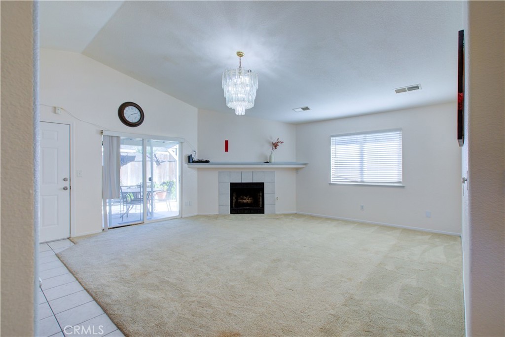 2341 Mesquite Court Merced, CA 95348 - Photo 2 of 17 an empty room with windows and fireplace