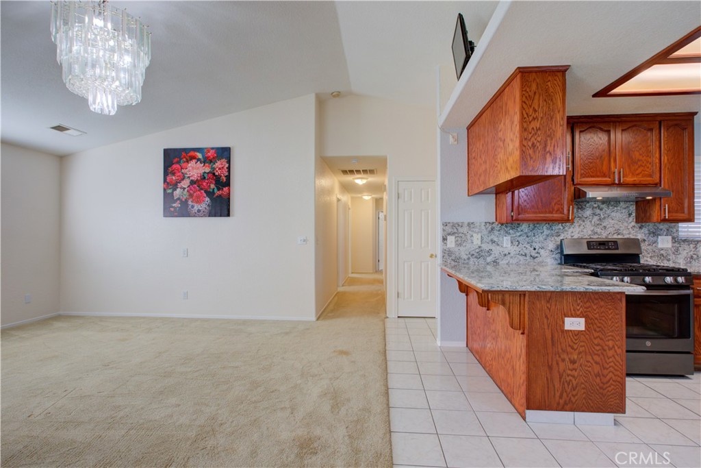 2341 Mesquite Court Merced, CA 95348 - Photo 4 of 17 a kitchen with stainless steel appliances granite countertop a stove a sink and a refrigerator