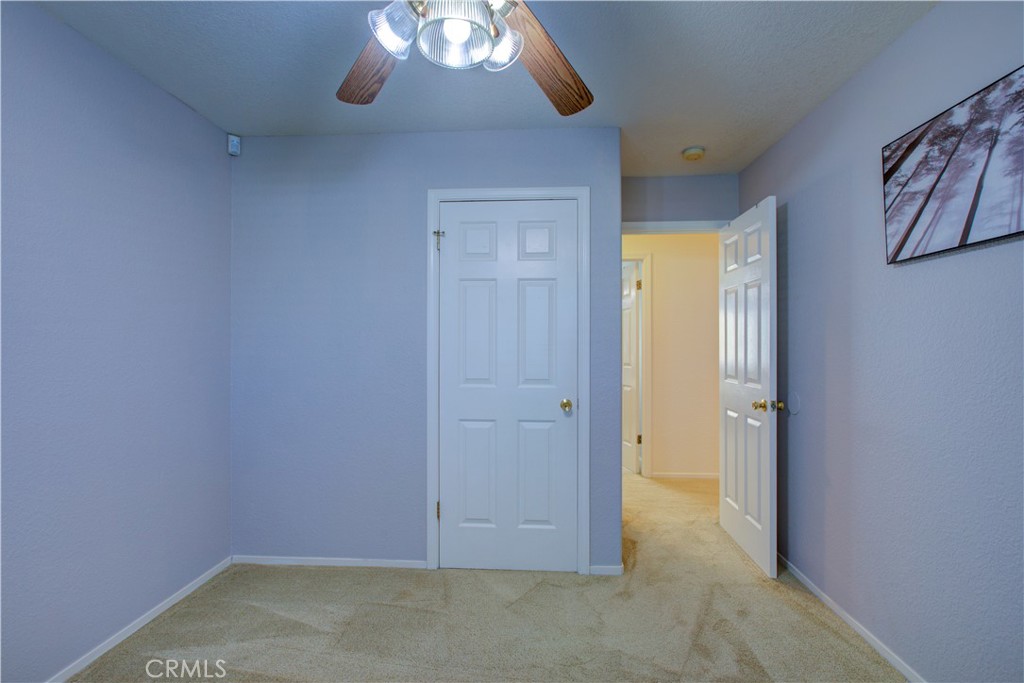 2341 Mesquite Court Merced, CA 95348 - Photo 9 of 17 an empty room with a empty space and a chandelier fan