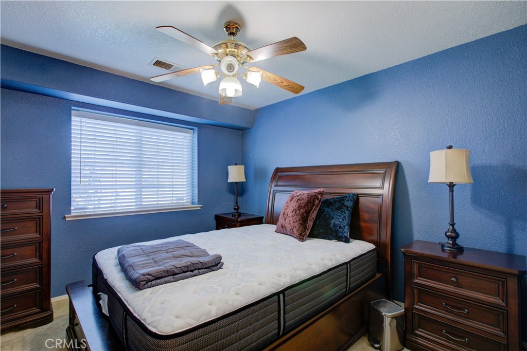 2341 Mesquite Court Merced, CA 95348 - Photo 10 of 17 a bedroom with a bed and a lamp