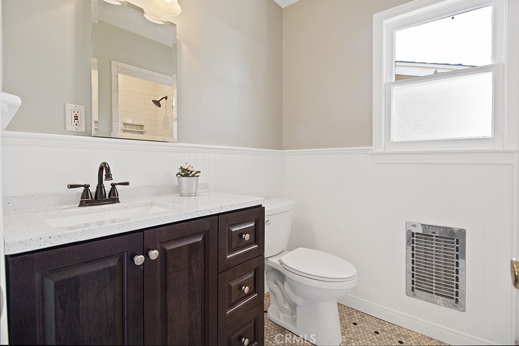 2726 Tapo Street Simi Valley, CA 93063 - Photo 13 of 48 a bathroom with a toilet a sink a vanity and mirror
