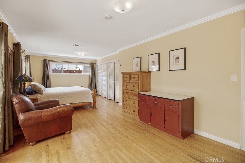 2726 Tapo Street Simi Valley, CA 93063 - Photo 18 of 48 a bedroom with a bed and wooden floor