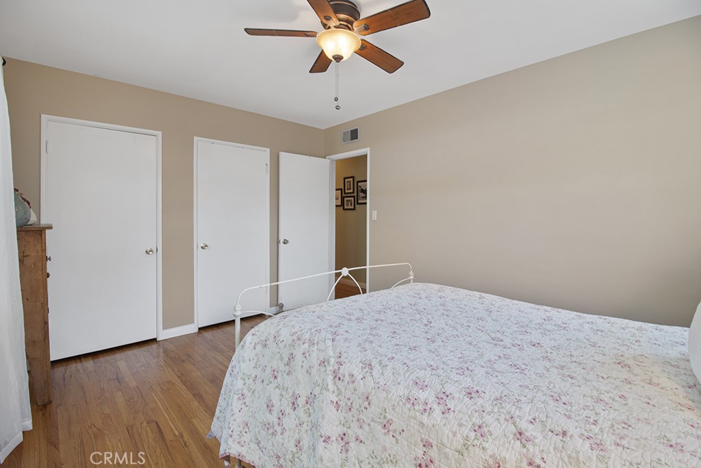 2726 Tapo Street Simi Valley, CA 93063 - Photo 23 of 48 a bedroom with a bed and a chandelier