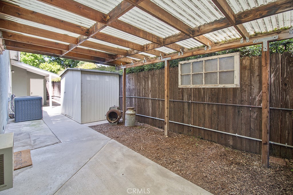 2726 Tapo Street Simi Valley, CA 93063 - Photo 25 of 48 a backyard of a house with lawn chairs and wooden fence