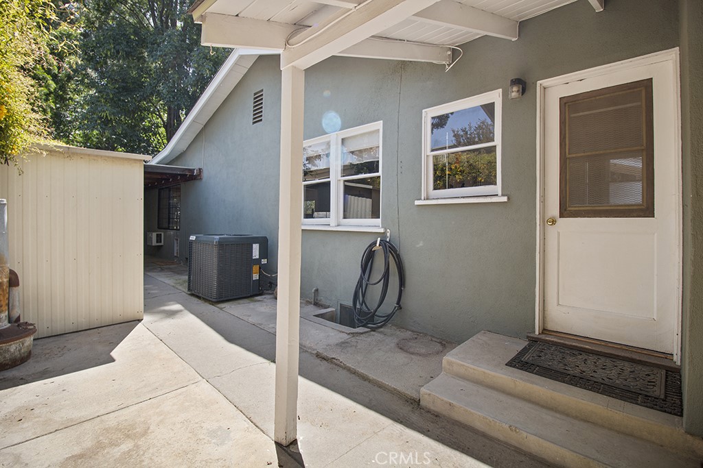 2726 Tapo Street Simi Valley, CA 93063 - Photo 26 of 48 a view of a house with a barbeque and wooden door