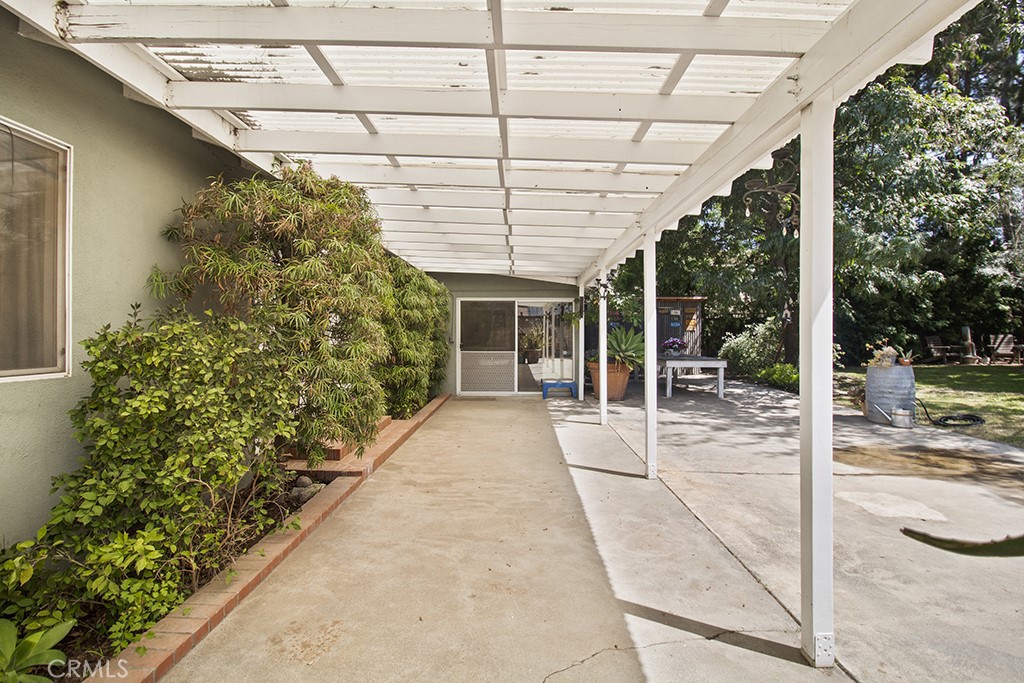 2726 Tapo Street Simi Valley, CA 93063 - Photo 30 of 48 a porch with a bench and potted plants