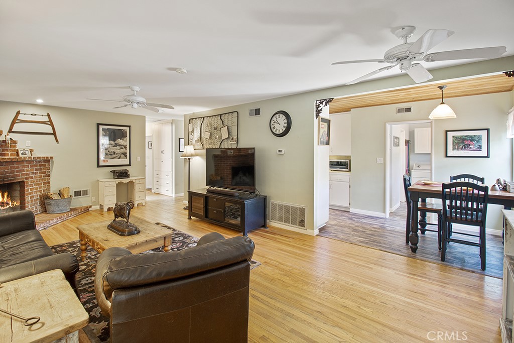 2726 Tapo Street Simi Valley, CA 93063 - Photo 6 of 48 a living room with furniture a fireplace and a flat screen tv