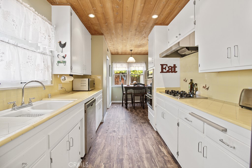 2726 Tapo Street Simi Valley, CA 93063 - Photo 9 of 48 a large kitchen with a lot of counter space and wooden floor