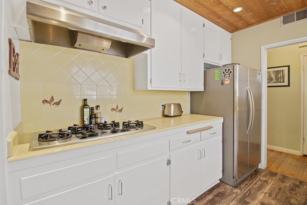 2726 Tapo Street Simi Valley, CA 93063 - Photo 10 of 48 a kitchen with cabinets and appliances