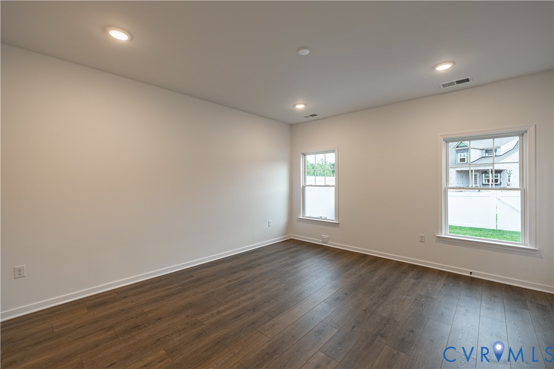 6715 Mayland Ridge Lane Moseley, VA 23120 - Photo 6 of 14 an empty room with wooden floor and windows