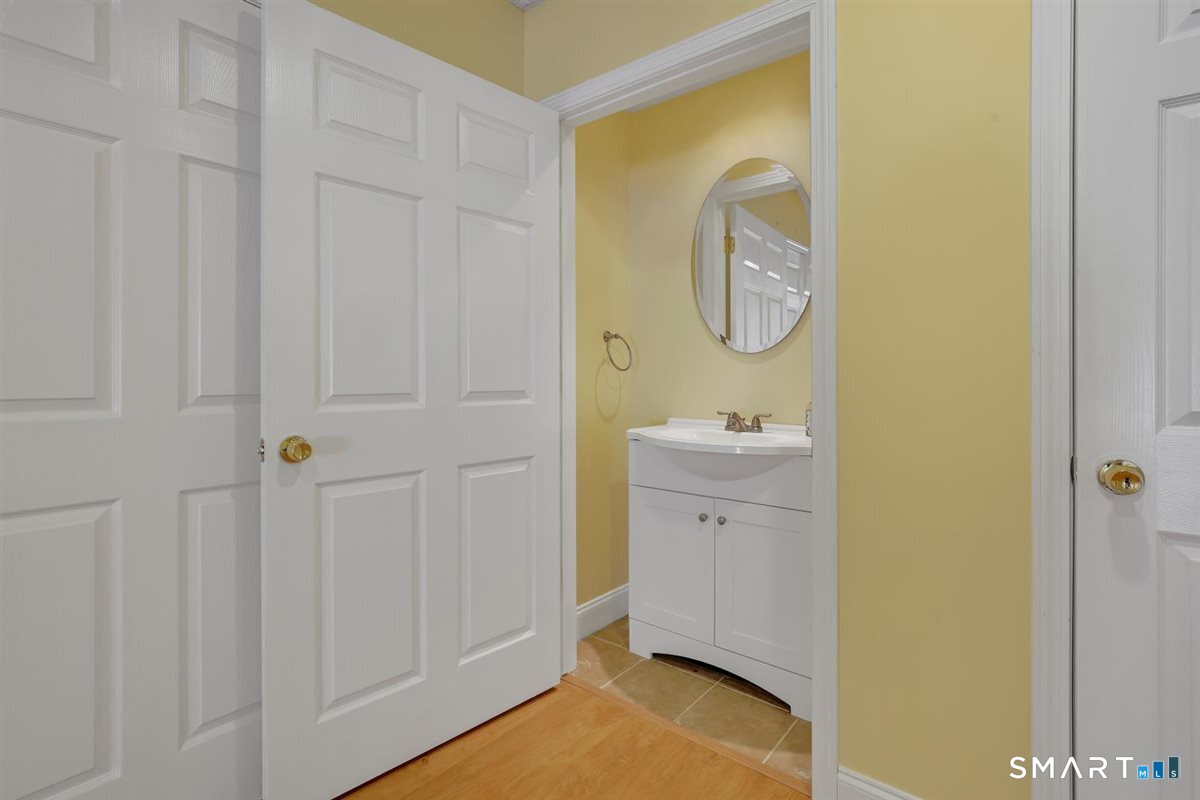 25 Fenwick Drive Avon, CT 06001 - Photo 35 of 40 a bathroom with a sink a toilet and a mirror