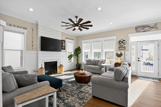 a living room with furniture a fireplace and a flat screen tv