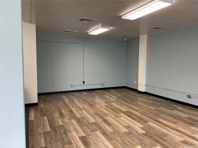 a view of a room with wooden floor and cabinet