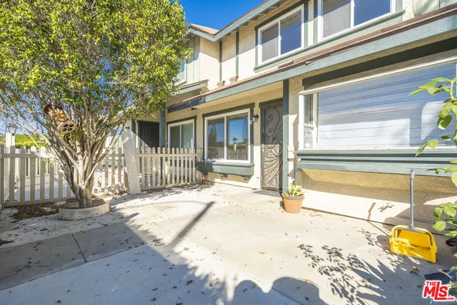 a view of an empty room with wooden floor and stairs
