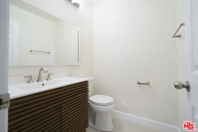 a spacious bathroom with a double vanity sink a mirror and a bathtub