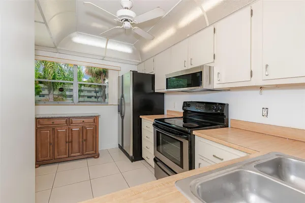 a kitchen with stainless steel appliances granite countertop a stove a refrigerator and a sink