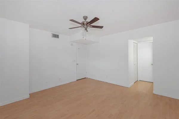 a view of a big room with a ceiling fan
