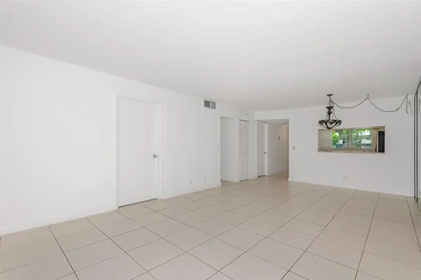 an empty room with a empty space and windows