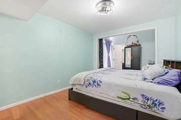 a bedroom with a bed and a chandelier