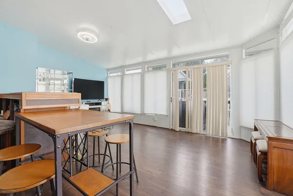 a view of a livingroom with furniture wooden floor and window