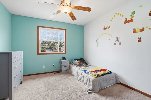 a bedroom with bed and a window