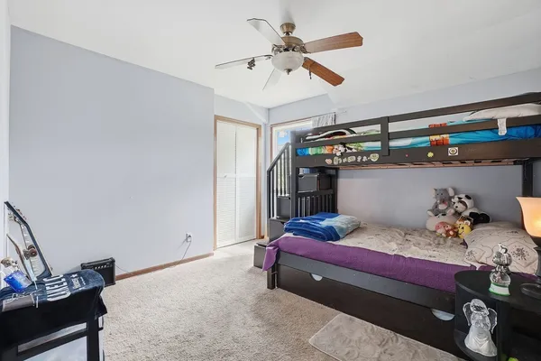 a bedroom with two beds and a window