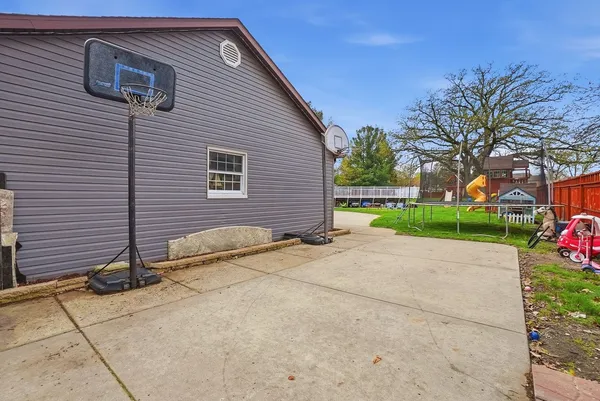 a view of a house with backyard sitting area and garden