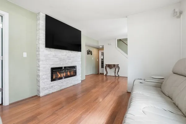 a living room with furniture fireplace and flat screen tv