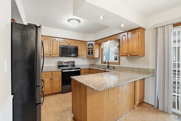 a kitchen with a refrigerator stove and sink