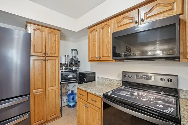 a kitchen with stainless steel appliances granite countertop a stove and a refrigerator