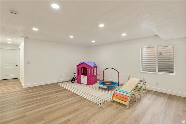 3916 South Sage Wood Avenue Mapleton, UT 84664 - Photo 21 of 33 Spacious lower-level room featuring wood-finish flooring, recessed lighting, and bright white walls
